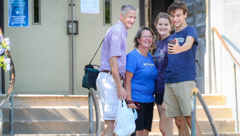 student taking a family picture