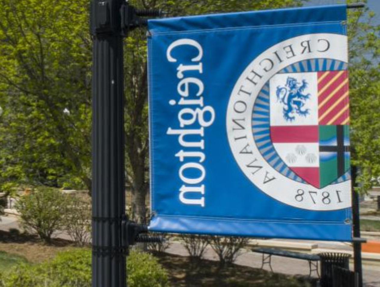 Creighton campus signage banner on sunny day