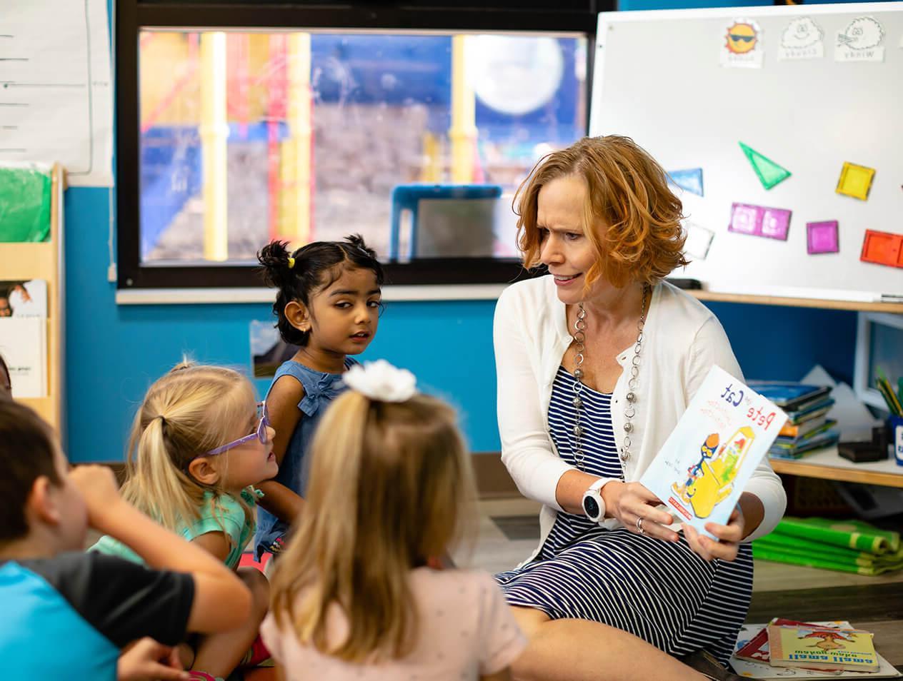 A teacher reading to young students