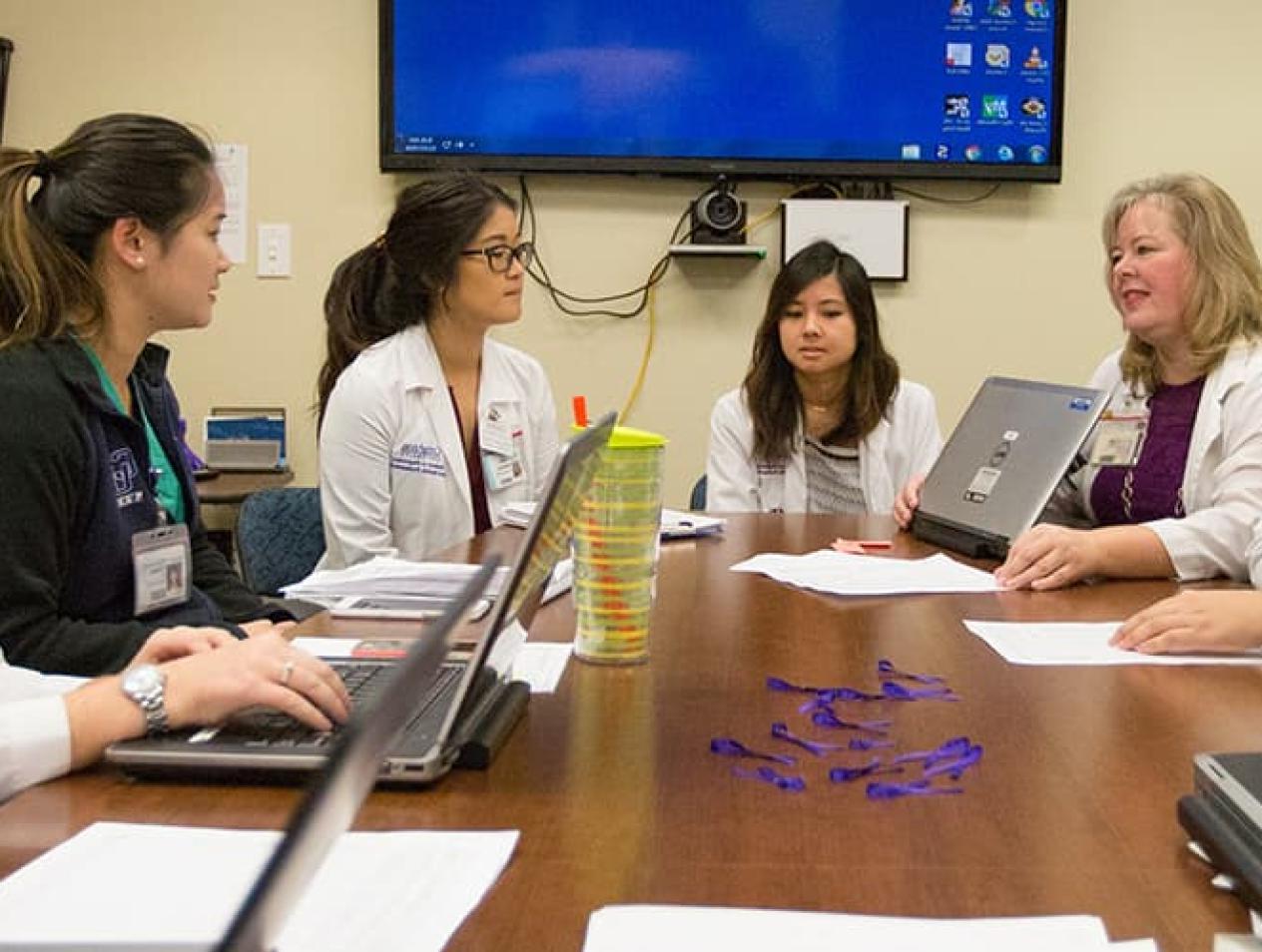 Students and faculty collaborating over research