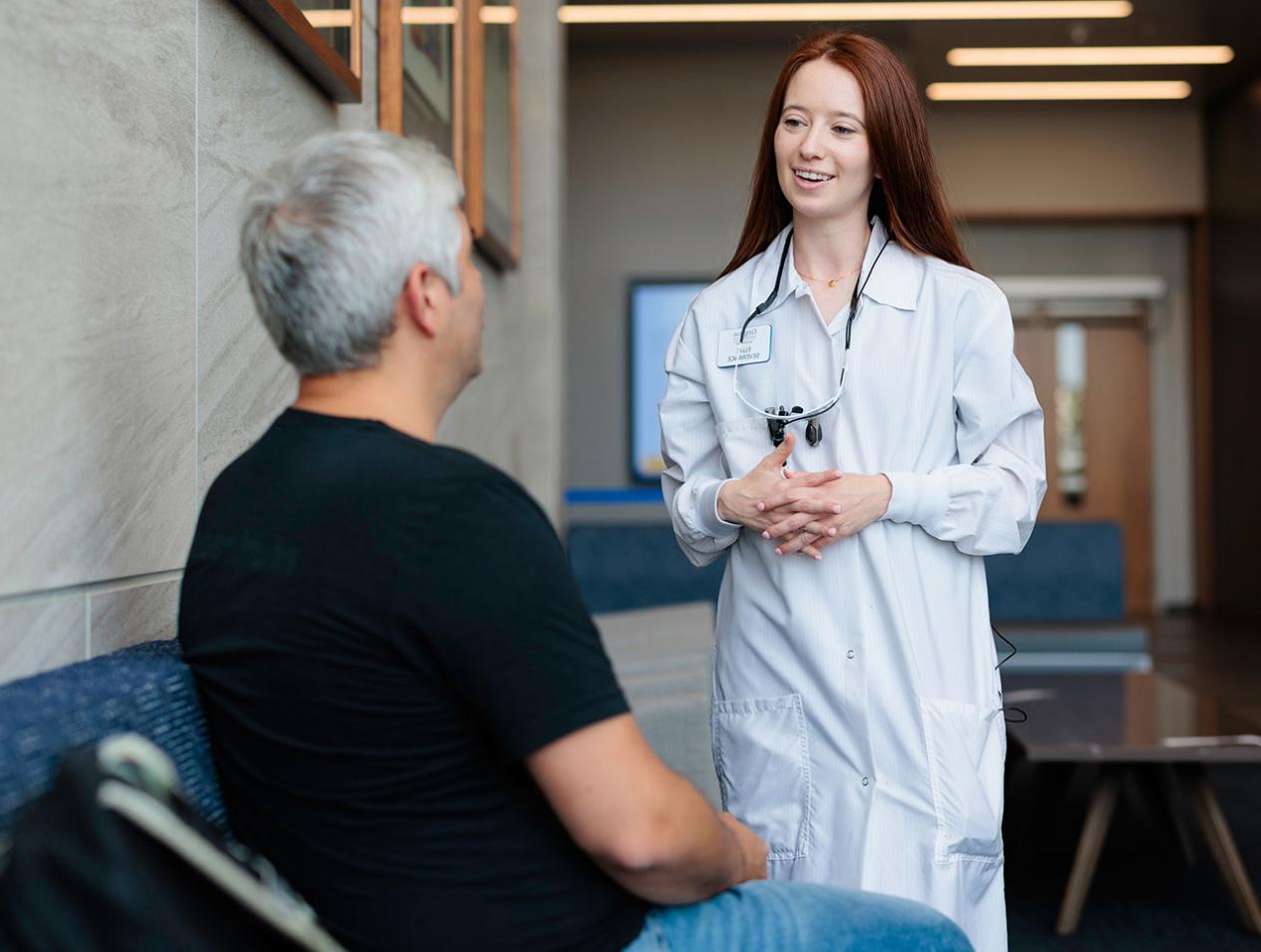 Dental student talking to patient