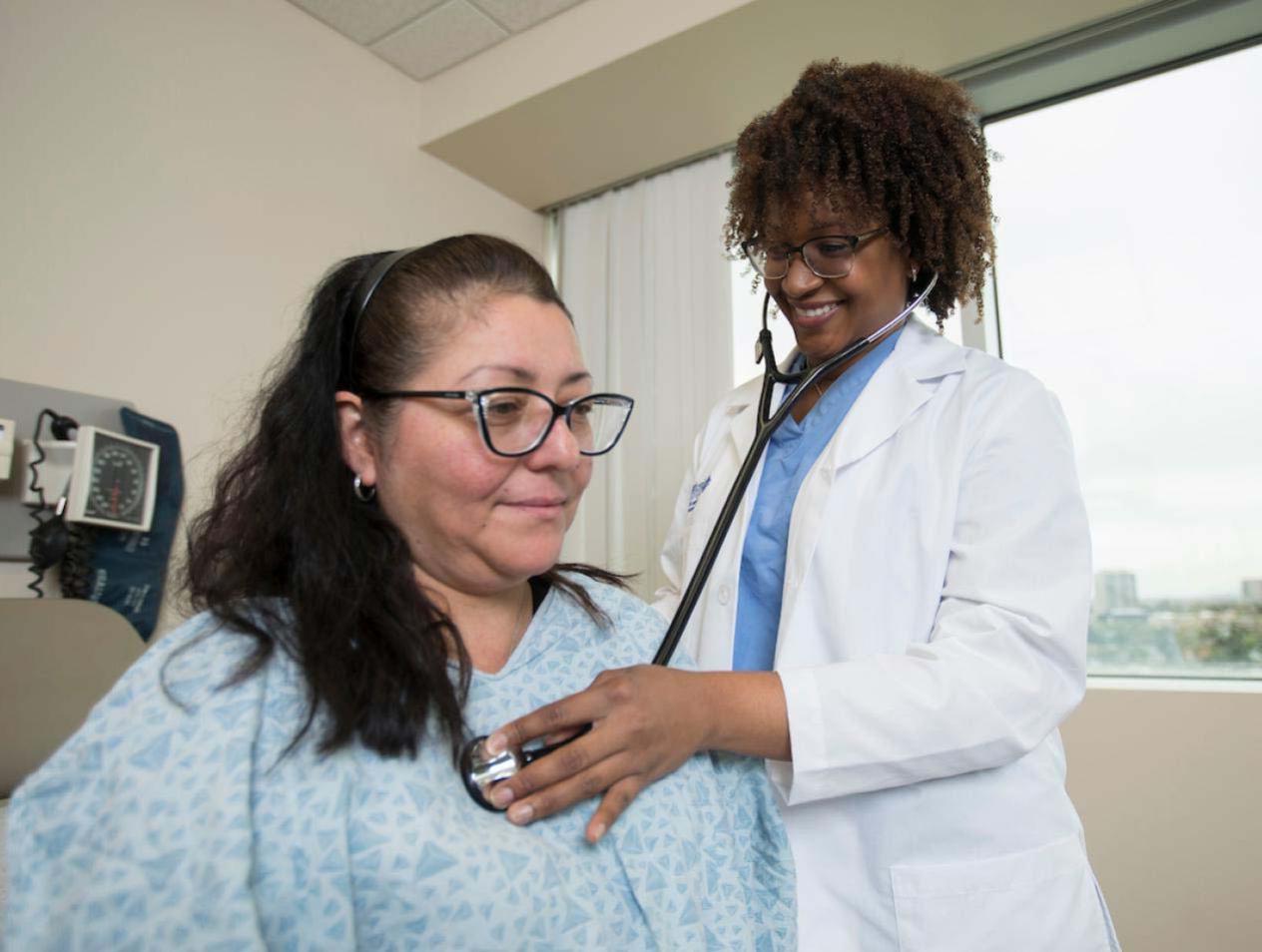 Examining patient in hospital room