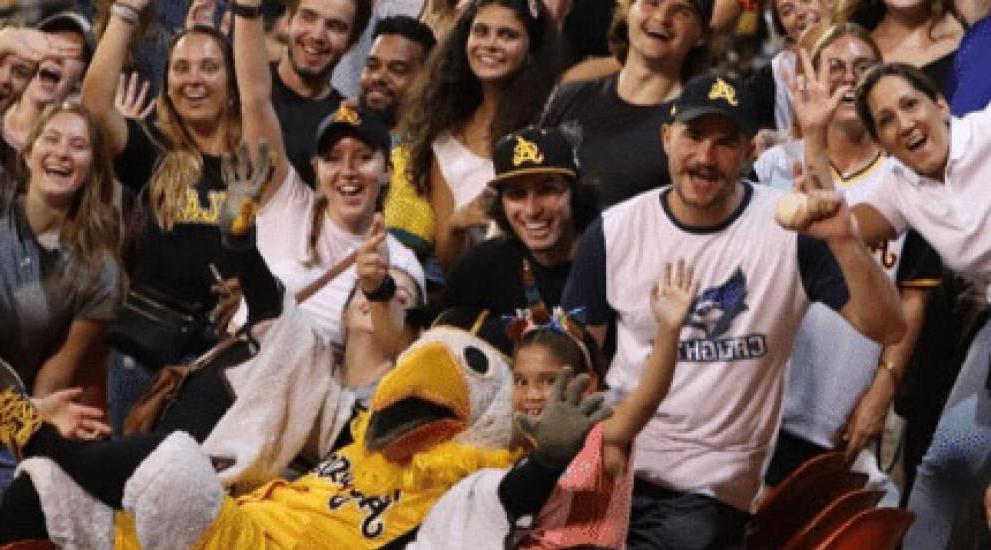 Students at a Las Aguilas Cibaenas baseball game