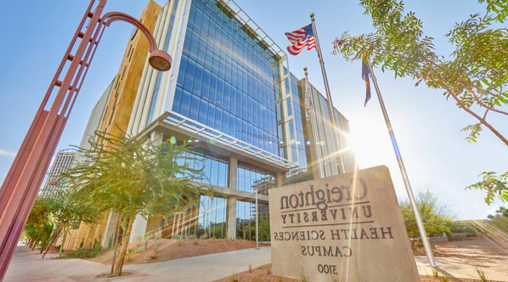 Creighton Health 科学 Campus building with sun beaming over one side.